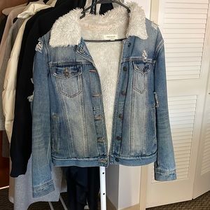 Blue denim jacket with fur and rips on arms